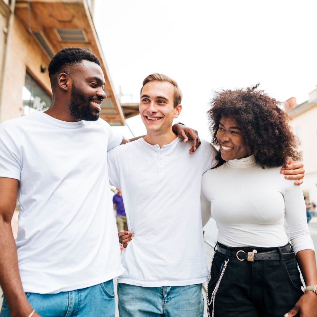smiley intercultural friends hugging
